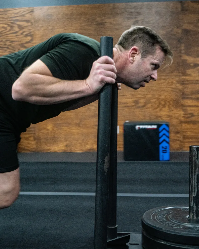 Patrick Kapenga mid-workout at a CrossFit gym, training intensely